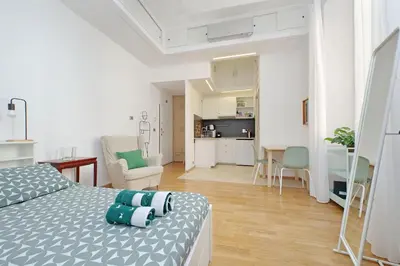 a bedroom with a bed and a living room at Delizioso loft all'Esquilino in Rome