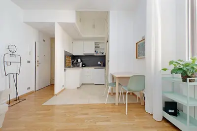 a kitchen and dining room with a table and chairs at Delizioso loft all'Esquilino in Rome