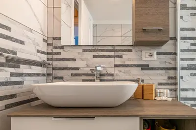 a bathroom with a white sink and a mirror at DOMVS Quattro Venti in Rome