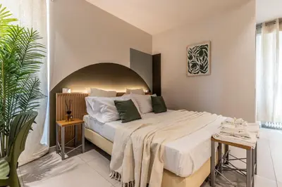 a bedroom with a large bed in a room at Dafne room Ampio nido, vera promessa di relax in Rome