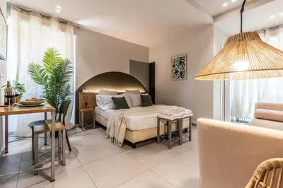 a bedroom with a bed and a table and a desk at Dafne room Ampio nido, vera promessa di relax in Rome