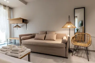 a living room with a couch and a chair at Dafne room Ampio nido, vera promessa di relax in Rome