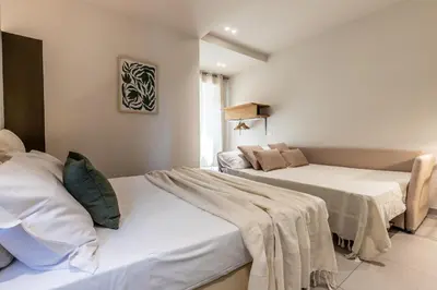 a living room with two beds and a couch at Dafne room Ampio nido, vera promessa di relax in Rome