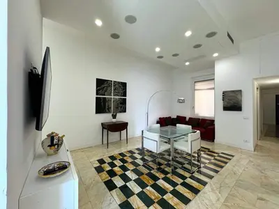 a living room with a glass table and a couch at Monti Central in Rome