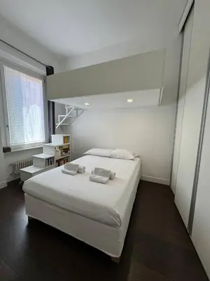 a bedroom with a large white bed with two pillows at Monti Central in Rome