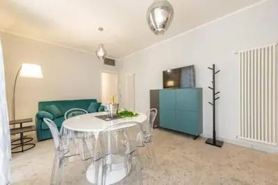 a living room with a table and a green couch at Heavenly Trevi Luxury Apartment in Rome