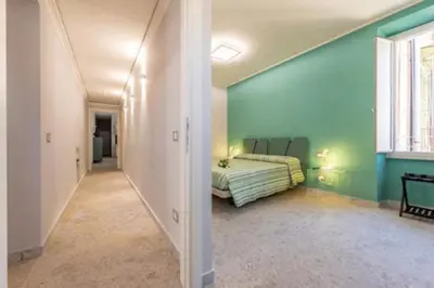 a bedroom with a bed in a blue wall at Heavenly Trevi Luxury Apartment in Rome