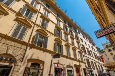 a large building with a sign in front of it at Heavenly Trevi Luxury Apartment in Rome
