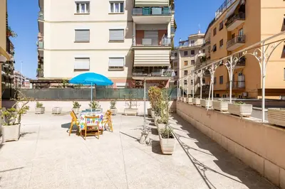 a patio with a table and chairs and an umbrella at Aurelia Dream with Terrace in Rome