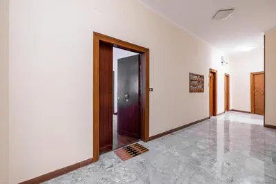 an empty hallway with a door and a tile floor at Aurelia Dream with Terrace in Rome