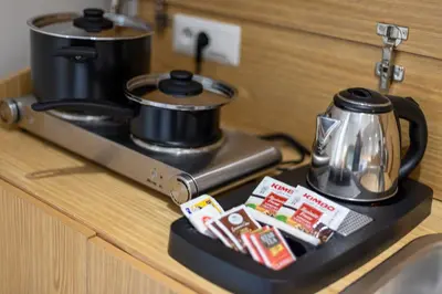 a stove with a pot and a tea kettle on it at Dafne room Speciale, elegante con balcone in Rome