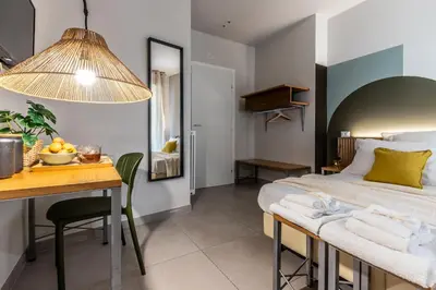 a bedroom with a bed and a desk and a table with a bowl of fruit at Dafne room Un'oasi romana per coppie in Rome