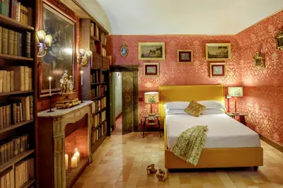 a bedroom with a bed in a room with bookshelves at Daplace - Villetta Sant'Onofrio in Rome