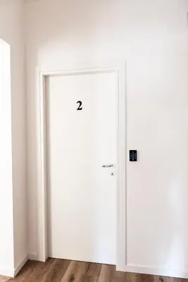 a white door in the corner of a room at Pascal boutique rooms in Rome