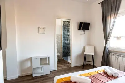 a bedroom with a bed and a tv and a mirror at Pascal boutique rooms in Rome