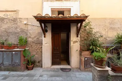 an entrance to a building with a wooden door at Alba Vatican Apartment in Rome