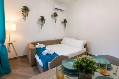 a small room with a bed and a table at Alba Vatican Apartment in Rome