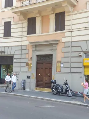 a motorcycle parked on a sidewalk in front of a building at Roma apartment near to Colosseum Re-House in Rome