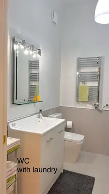 a bathroom with a sink and a toilet and a mirror at 3Bdr Apartment in the heart of Rome in Rome