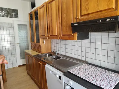 a kitchen with wooden cabinets and a sink at da Giò a Trastevere in Rome