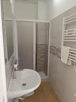 a white bathroom with a sink and a shower at da Giò a Trastevere in Rome
