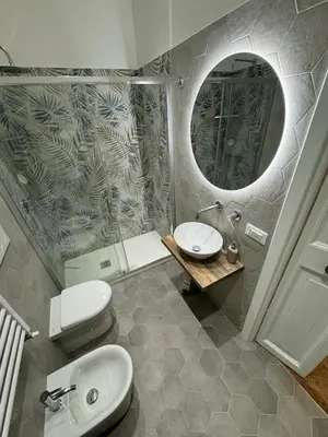 a bathroom with a toilet and a sink and a mirror at Carrozze apartment in Rome