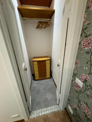 a hallway with a small room with a table and a drawer at Carrozze apartment in Rome
