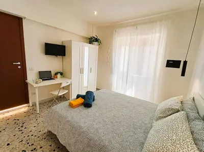a bedroom with a bed and a desk with a laptop at Pi gneto GH Locazione Turistica in Rome