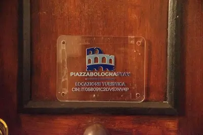 a sign on a door with a building on it at PiazzaBolognaStay in Rome