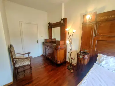 a room with a bed and a dresser and a chair at Double- Room Basilica San Paolo in Rome