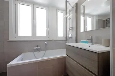 a bathroom with a tub and a shower and a sink at Appartamento 