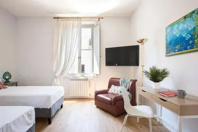 a hotel room with a bed and a chair and a desk at Casa Marchese Lucia in Rome