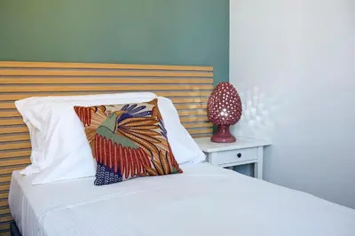 a bed with a wooden headboard and a pillow on it at Casa Marchese Lucia in Rome