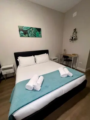 a bedroom with a bed with two towels on it at D Guest House in Rome