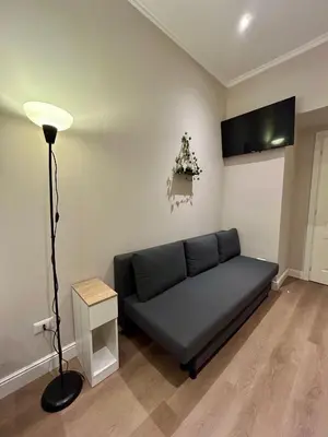 a living room with a couch and a lamp at D Guest House in Rome