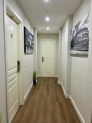 an empty hallway with a white door and a white hallway sidx sidx sidx at D Guest House in Rome