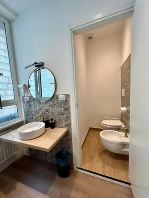 a bathroom with two sinks and two toilets at D Guest House in Rome