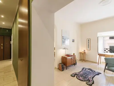 a living room with a blue chair and a rug on the floor at Apartment Alessandria Home by Interhome in Rome