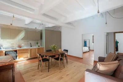 a kitchen and living room with a table and chairs at iFlat Peaceful brand new 2beds apt in Trastevere in Rome