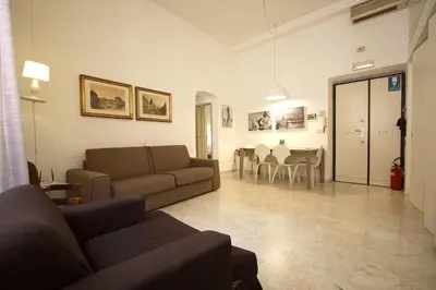 a living room with a couch and a dining room at Navona New Charming Apartment in Rome