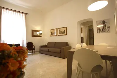 a living room with a couch and a table and chairs at Navona New Charming Apartment in Rome