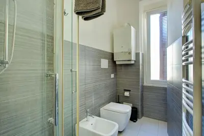 a bathroom with a toilet and a sink and a shower at Casetta 79 in Rome