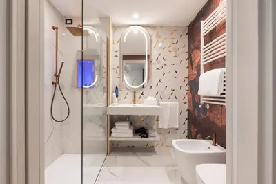 a bathroom with a sink and a mirror at Je Rome Hotel in Rome