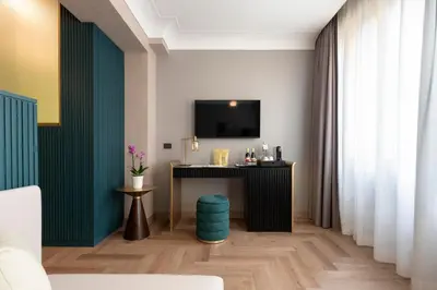a room with a table and a tv on a wall at Je Rome Hotel in Rome