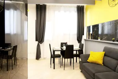 a living room with a table and a couch at Trastevere golden luxury loft in Rome