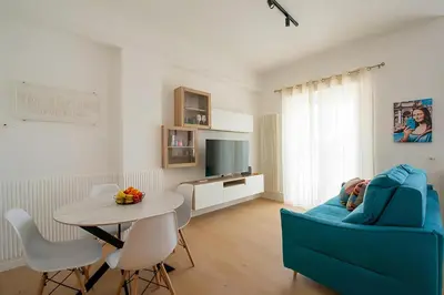 a living room with a blue couch and a table at The Ciccins Apartment in Rome by Hostand in Rome