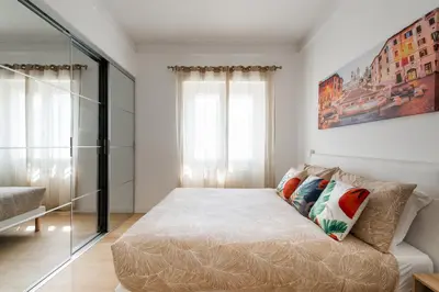 a small bedroom with a bed and a window at The Ciccins Apartment in Rome by Hostand in Rome