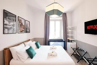 a small bedroom with a bed and a couch at Elegant Apartment with view of Castel Sant'Angelo in Rome