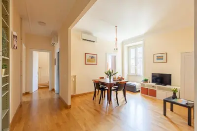 a dining room and living room with a table at iFlat Bright & Comfy 2-Bedroom Apt near Vatican in Rome