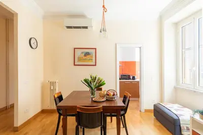 a dining room with a table and chairs at iFlat Bright & Comfy 2-Bedroom Apt near Vatican in Rome